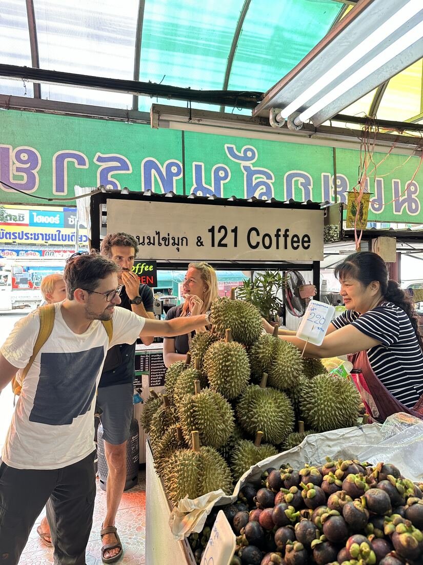 Guests exploring a local Chiang Mai market with Baan Farm Thai Cooking School