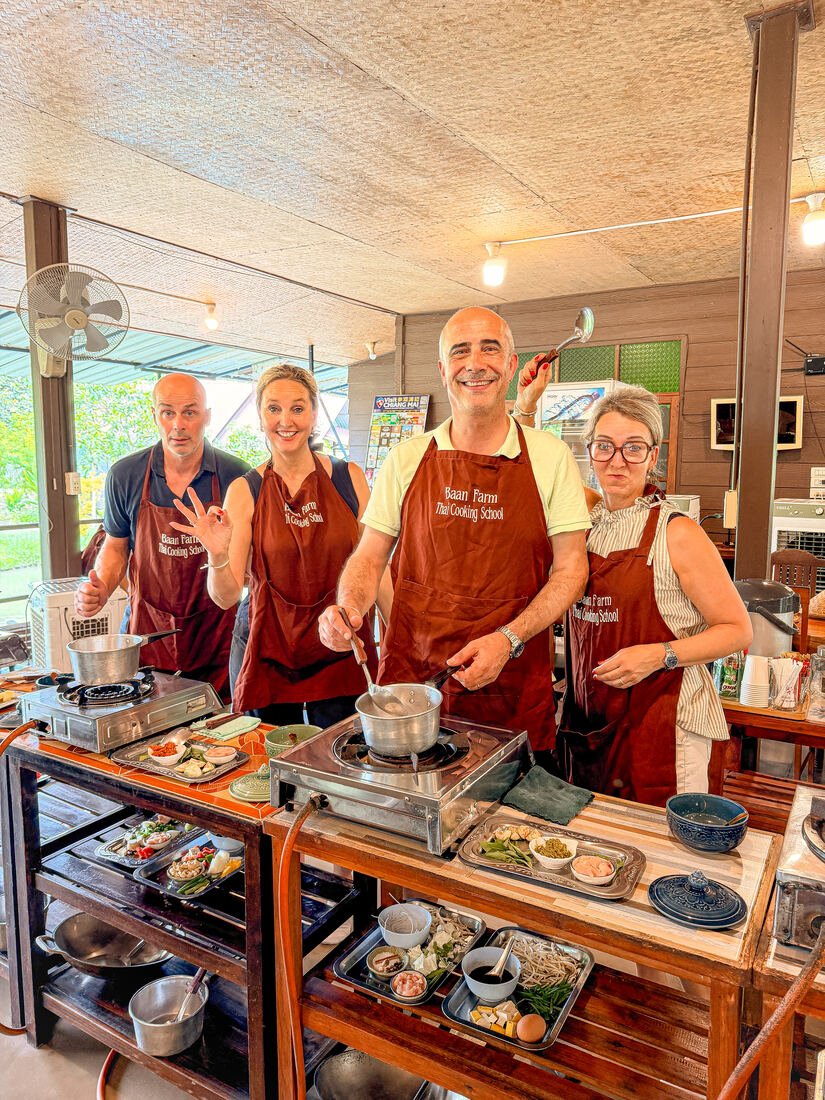 Guests cooking Thai dishes with instructors at Baan Farm