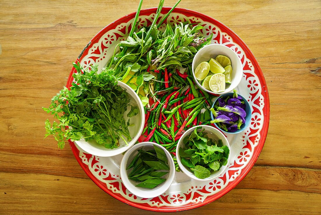 Fresh herbs and vegetables prepared for a Baan Farm Thai Cooking School class