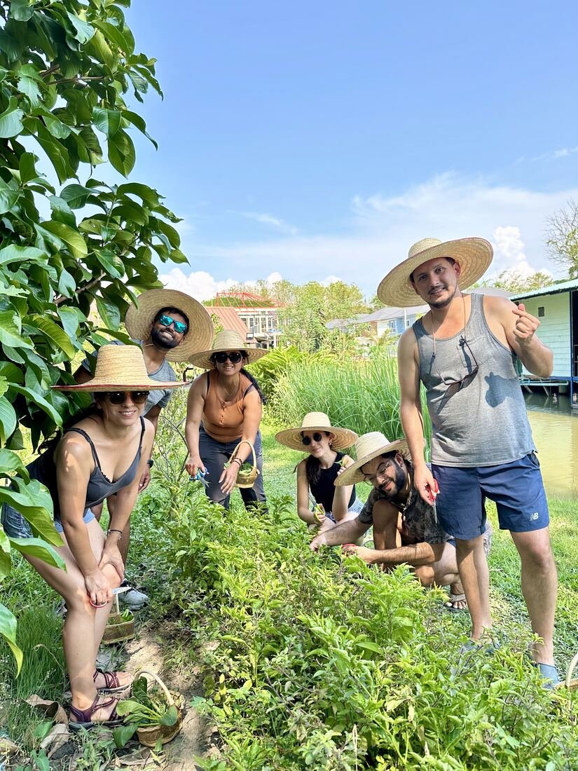 Guests on a garden tour at Baan Farm Thai Cooking School