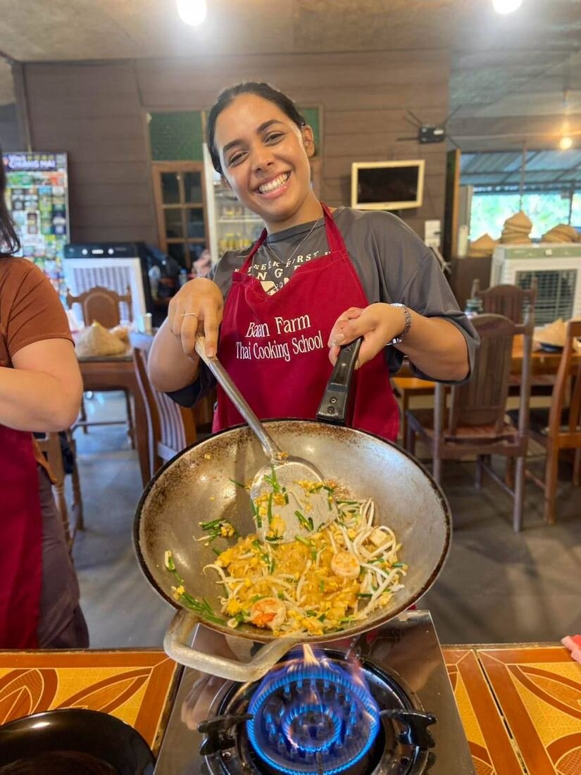 Instructor cooking with a guest at Baan Farm Thai Cooking School