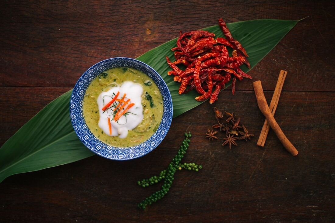 Tom kha soup in a traditional bowl at Baan Farm Thai Cooking School
