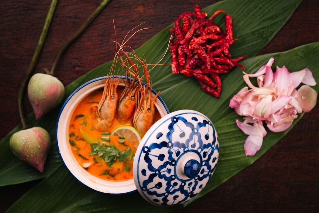 Thai tom yum soup with prawns, plated at Baan Farm Thai Cooking School